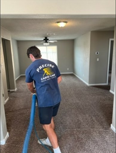 A Precise Carpet Care technician cleaning residential carpet in a home in Albuquerque, NM.
