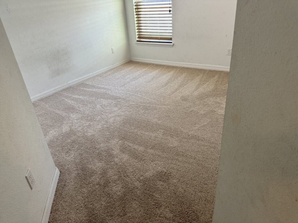 A clean, newly installed light brown carpet in a residential room by First Quality Carpets Inc. in Orlando, FL