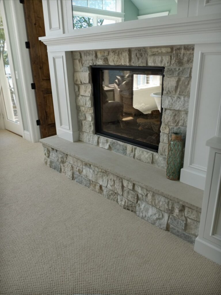 A cozy living room featuring new light-colored carpet installed by Great Spaces Floor Co in Minneapolis, MN.