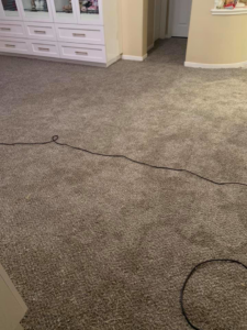 A view of a freshly installed gray carpet in a residential room by Topline Flooring in Houston, TX.