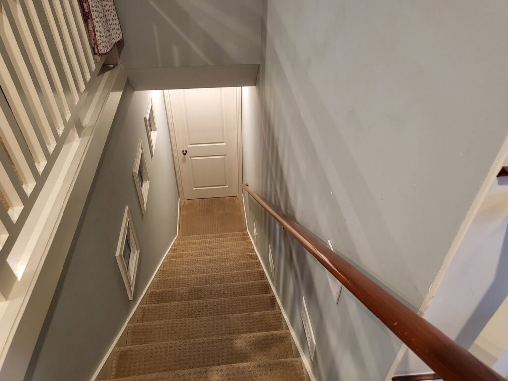 A clean, light-colored residential carpeted staircase, ready for use, by Greenco2 in Grand Rapids, MI.