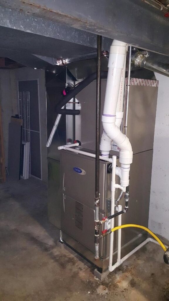 A residential Carrier furnace and air handler unit installed by Polar Aire Heating & Cooling in Olathe, KS