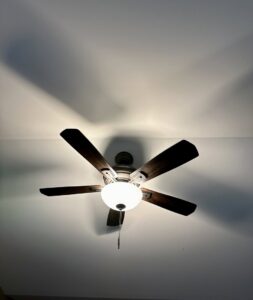 A modern ceiling fan with integrated lighting installed in a residential room by Lighten Up Electric, LLC in Cranston, RI.