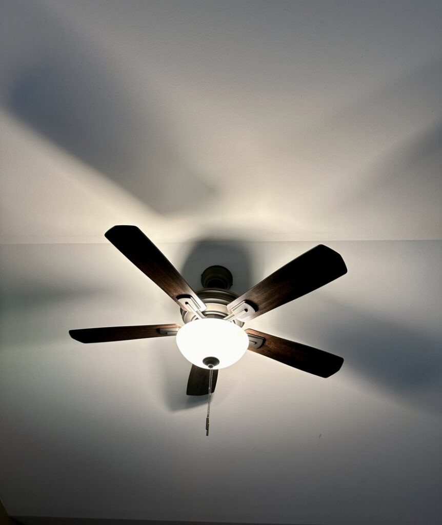 A modern ceiling fan with integrated lighting installed in a residential room by Lighten Up Electric, LLC in Cranston, RI.