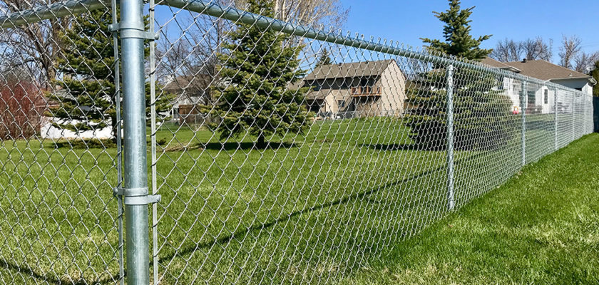 A residential chain-link fence installation by Lawrence Fence Company in Lawrence, KS.