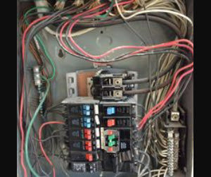 A residential circuit breaker panel with colorful wiring, expertly maintained by BR Electric in Newcastle, OK.