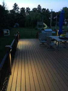 Residential deck with custom post lighting installed by McPhillips Electric LLC in Columbus, NE, enhancing outdoor living.