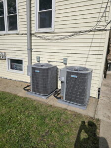 Two residential outdoor AC units installed by Brothers Heating & Cooling Inc. in Chicago, IL.