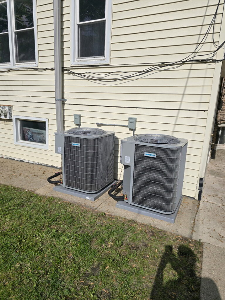 Two residential outdoor AC units installed by Brothers Heating & Cooling Inc. in Chicago, IL.