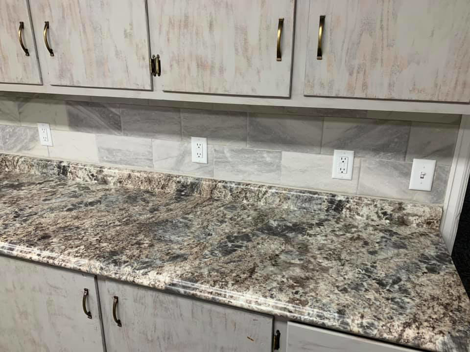 An open residential electrical breaker panel with neatly organized colored wiring by AMG Electric LLC Laramie, WY.