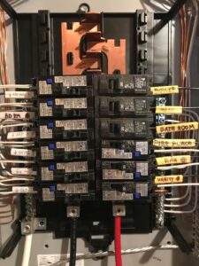 Residential electrical breaker panel with labeled circuits, installed by Apex Electrical Solutions in Minot, ND.