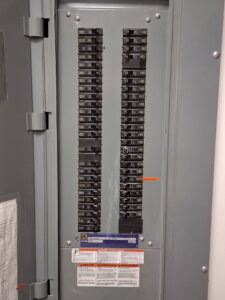 A close-up view of a modern electrical breaker panel installed by Helm Electric in Salina, KS