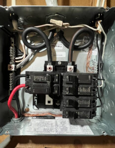 A residential electrical breaker panel with wiring and circuit breakers installed by Raschke & Sons Electric in Chattanooga, TN