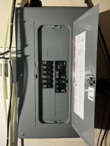 An open residential electrical breaker panel showing circuit breakers, serviced by Richard Sullivan Licensed Electrician in Brockton, MA.