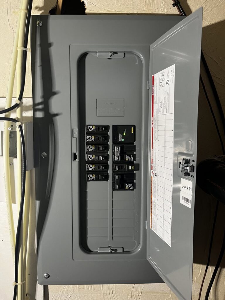 An open residential electrical breaker panel showing circuit breakers, serviced by Richard Sullivan Licensed Electrician in Brockton, MA.