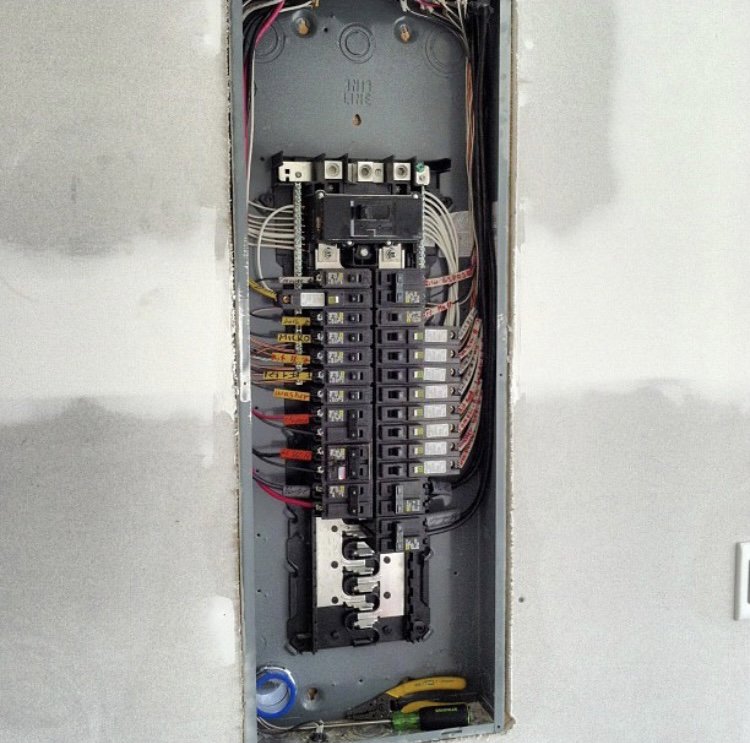An open residential electrical breaker panel with neatly wired circuits by Pierce Electric, LLC in Fayetteville, NC