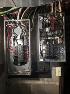 Two open residential electrical breaker panels with wiring by Bonham Electric, Inc. in Sacramento, CA.