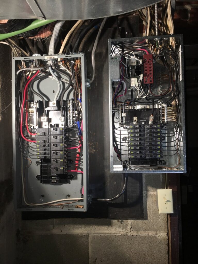 Two open residential electrical breaker panels with wiring by Bonham Electric, Inc. in Sacramento, CA.