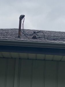 An electrical mast and service wires on a residential roof, demonstrating the exterior electrical work provided by AA Electric Contractors in Chicago, IL.
