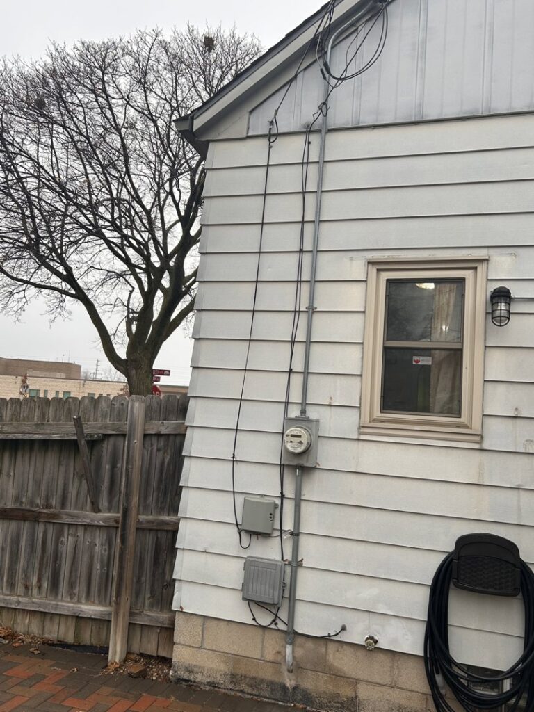 Residential electrical meter and conduit installation on a house by Advance Electrical Contractors in Milwaukee, WI.