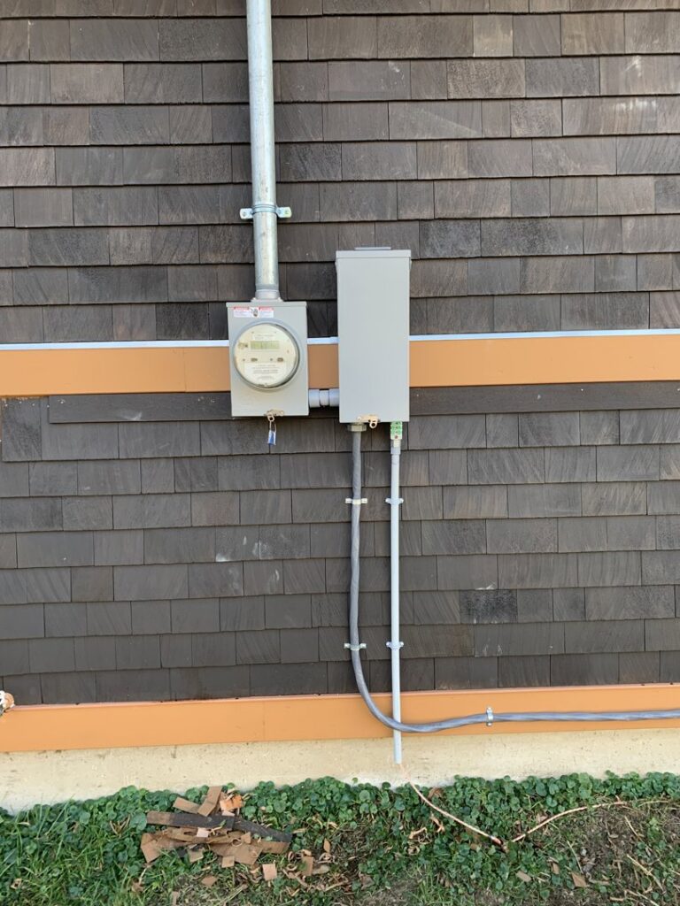 A residential electrical meter and main disconnect box installed on a home by Building Connections LLC in Auburn, ME.