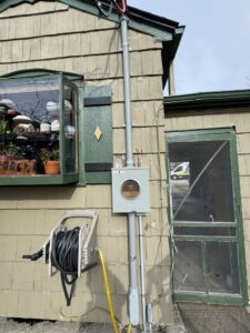 An exterior residential electrical meter and conduit installation by Pure Light Electric in Kansas City, MO.