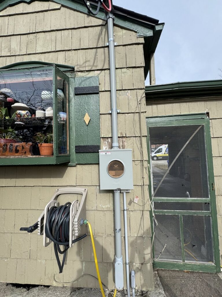 An exterior residential electrical meter and conduit installation by Pure Light Electric in Kansas City, MO.