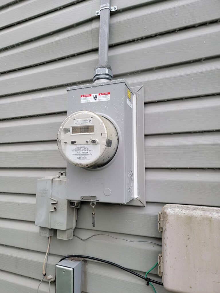 Close-up of a residential electrical meter and conduit installed by The Dorky Electrician, LLC in Coplay, PA