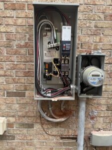 Residential electrical meter and service panel installed on a brick wall by Electric R US LLC in Dearborn, MI.