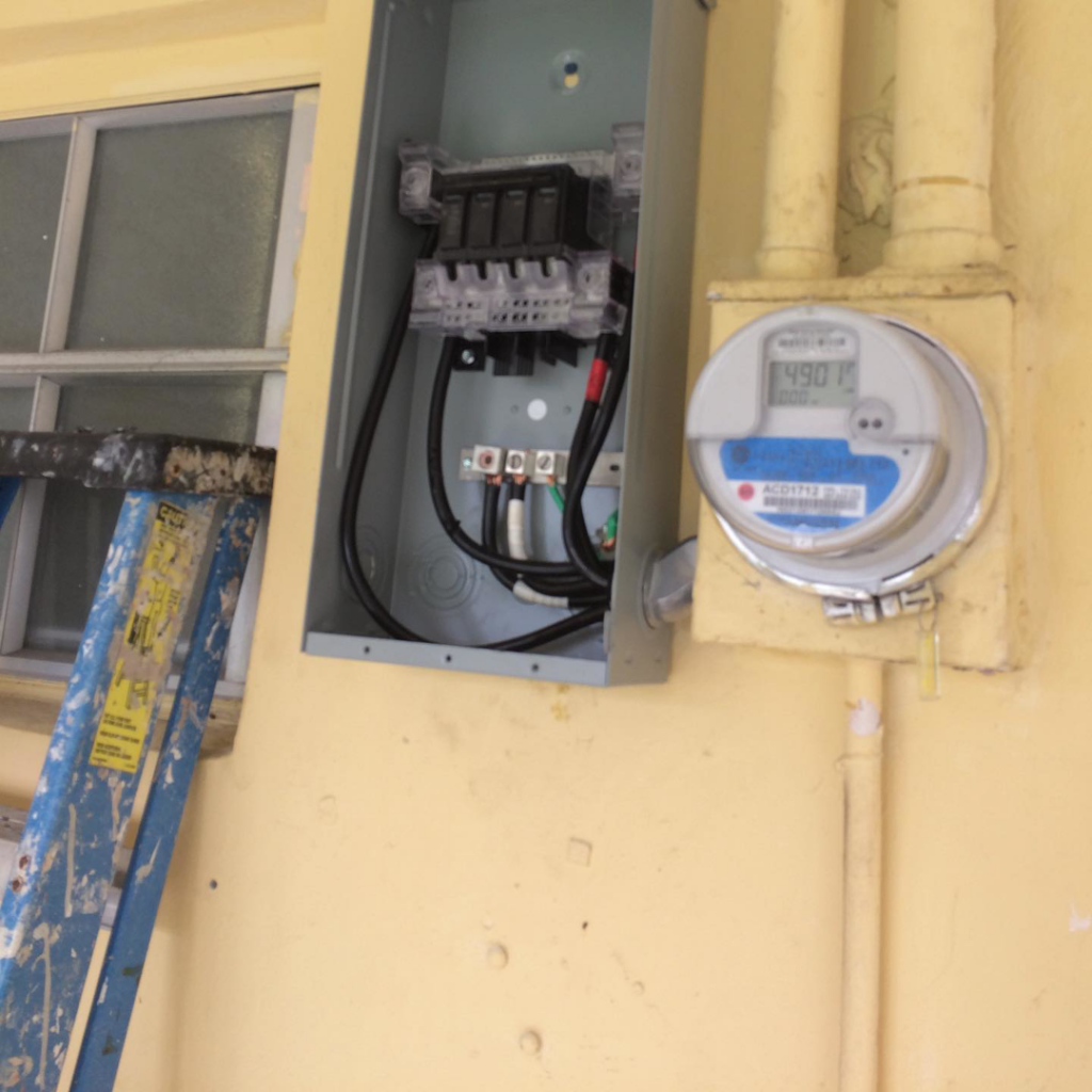 A residential electrical meter and open service panel installation by Electriciansonway in Hollywood, FL