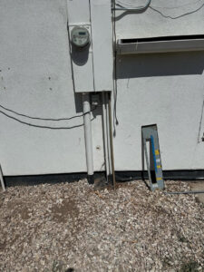 A residential electrical meter and service panel on the exterior of a home, installed by MCM Electrical Services LLC in Phoenix, AZ