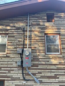 An exterior view of a residential electrical meter and service entrance installed by Elite Electric Company in Melrose Park, IL
