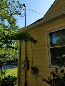 Exterior view of a residential electrical meter and service mast installed by Jeremy Electrical in Roeland Park, KS.