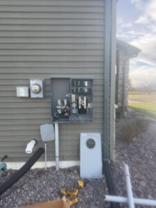Exterior residential electrical meter and service panel installation by Apex Electrical Solutions in Minot, ND.