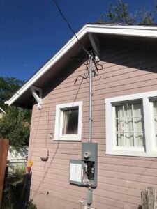 A residential electrical meter and service entrance on the side of a house, installed by JJRS Electrical, LLC in Colorado Springs, CO.