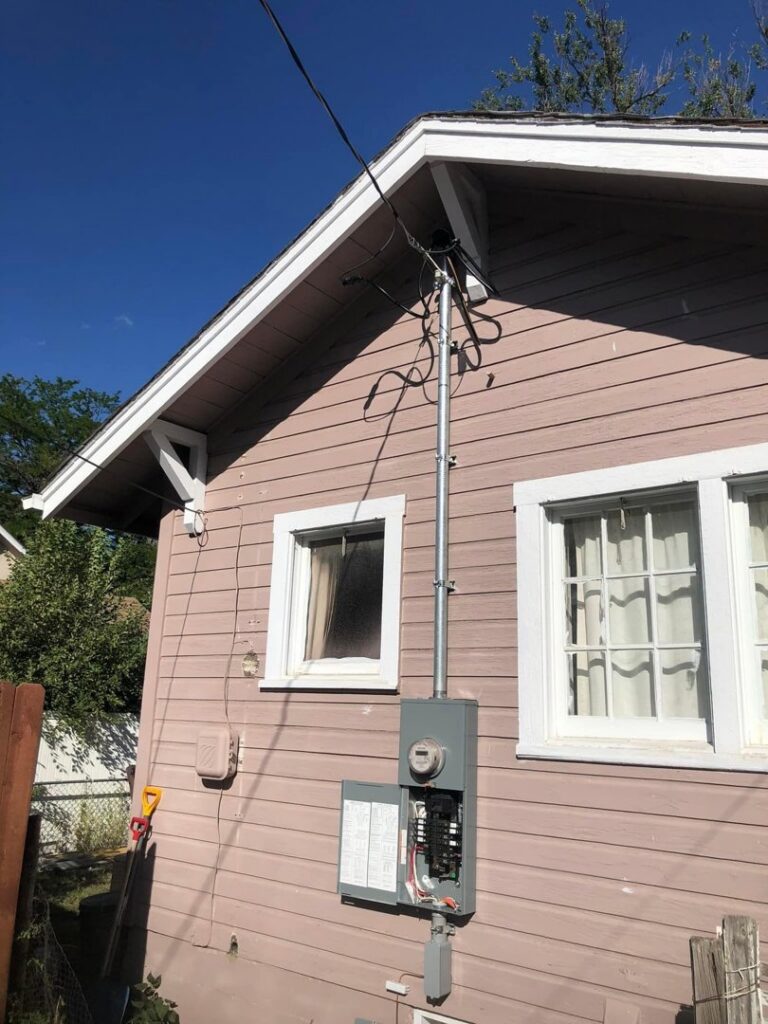 A residential electrical meter and service entrance on the side of a house, installed by JJRS Electrical, LLC in Colorado Springs, CO.