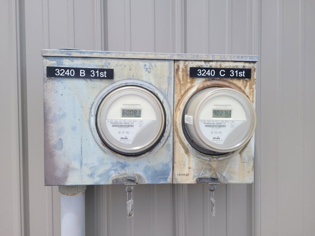Residential electrical meters on an exterior wall, serviced by FOXX & Hounds Electric in Sioux City, IA.