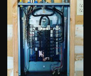 A residential electrical panel with circuit breakers and wiring, serviced by BR Electric in Newcastle, OK.