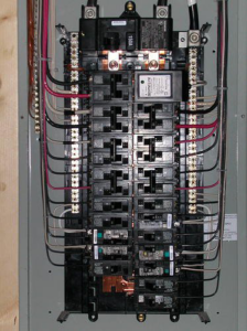 An open residential electrical panel with circuit breakers and wiring, serviced by Electric Experts Inc in Caldwell, ID.