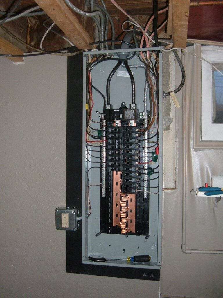 An open residential electrical panel or breaker box being serviced by Acme Electrical & Ac Services Inc in Tampa, FL.