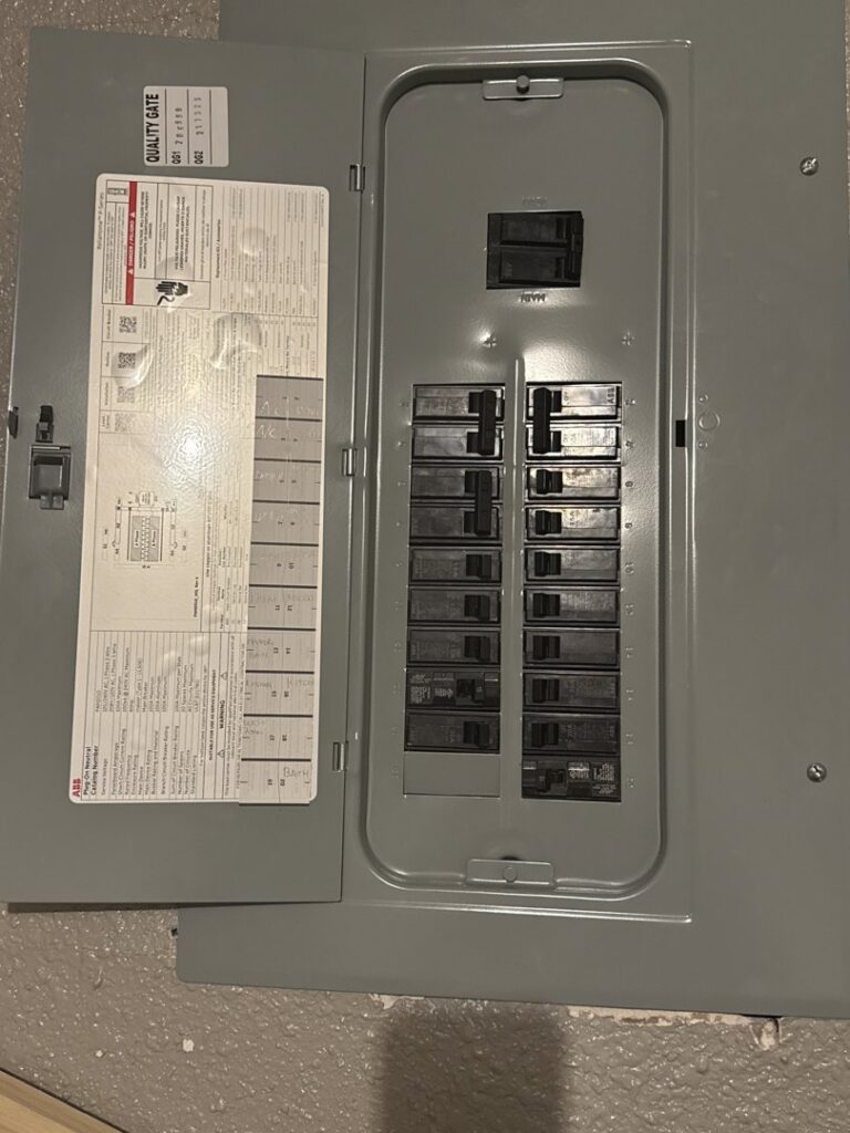 An open residential electrical panel showing circuit breakers, demonstrating work by Bottom To The Top Electric LLC in Lakewood, CO.