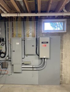 Residential electrical panel and Generac generator transfer switch installed by Cummings Electric in South Burlington, VT.