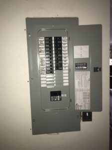 An open residential electrical panel showing circuit breakers, serviced by 60HZ Electric in St. Petersburg, FL.