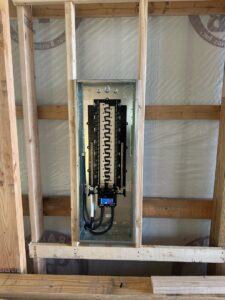 A residential electrical panel installation within wooden framing by Electric Today in Indianapolis, IN.