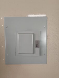 A neatly installed residential electrical panel on a wall, representing the quality work of Envision Electrical Solutions in Fort Lauderdale, FL.