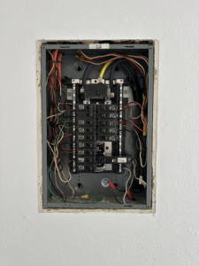 A neatly wired residential electrical panel with circuit breakers, installed by Watts Happening Electric in Lakewood, CO.
