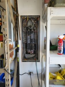 An open residential electrical panel with circuit breakers and wiring, installed by Minards Electric LLC in Dickinson, ND.