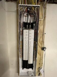 A residential electrical panel with neatly organized wiring and circuit breakers by Pure Light Electric in Kansas City, MO.