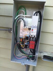 An open residential electrical panel showing wiring and circuit breakers, installed or serviced by ACI Northwest Heating, Cooling & Electrical in Dalton Gardens, ID.