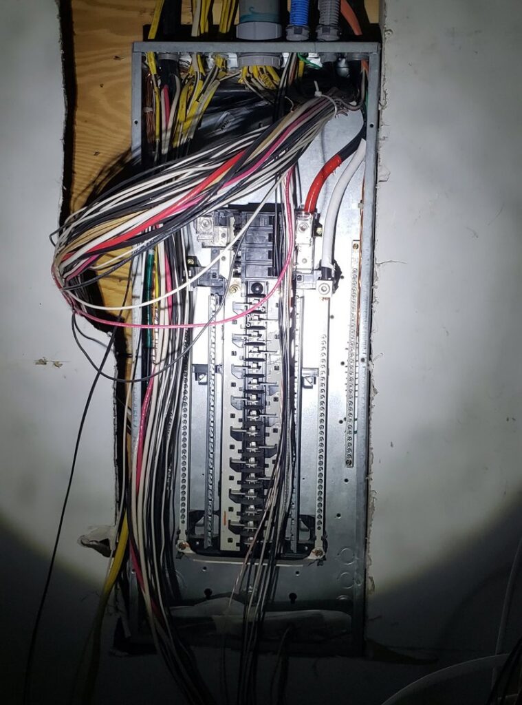 An open residential electrical panel with extensive wiring, serviced by Electricians On Call in Fort Lauderdale, FL.